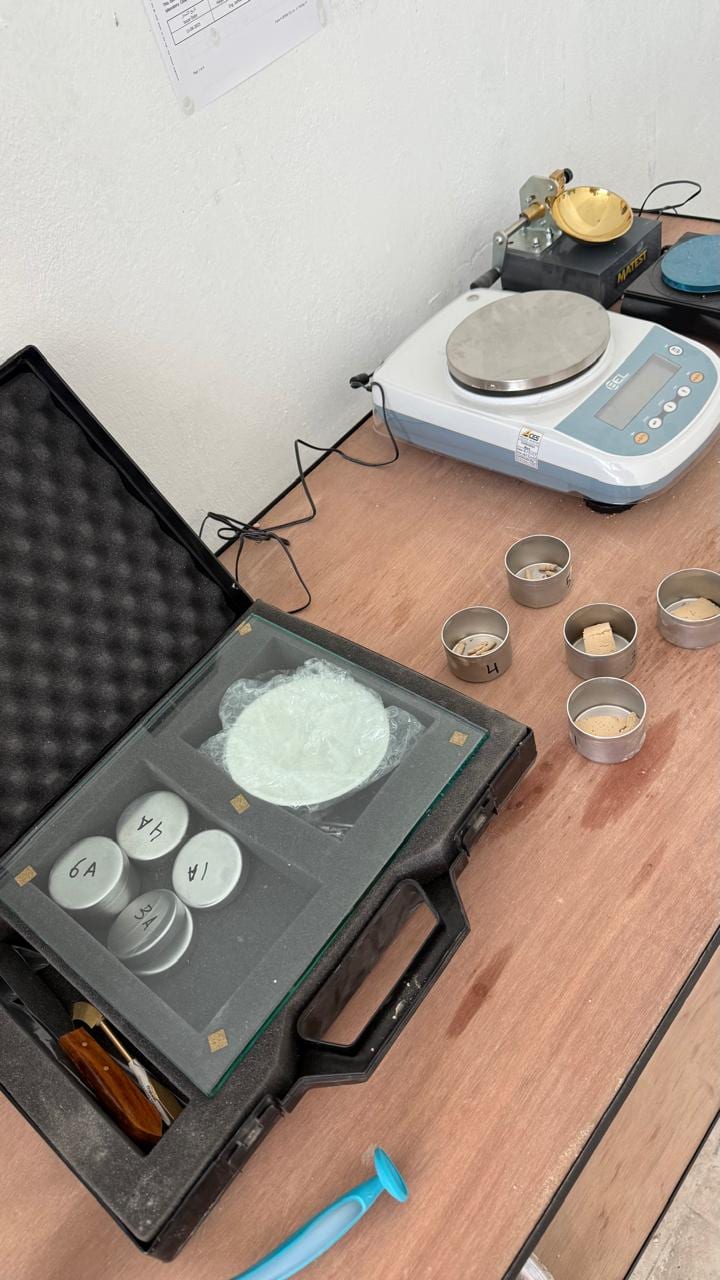 The Atterberg bench, with the precision balance and moisture tins